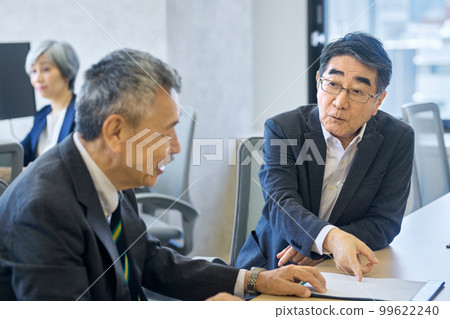 Senior businessman in a suit having a meeting in the office 99622240
