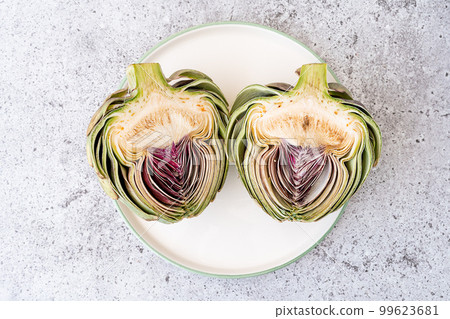 Top view Sliced artichoke on plate on table. Healthy food vegetables. Top view Sliced artichoke on plate on table. Healthy food vegetables. 99623681