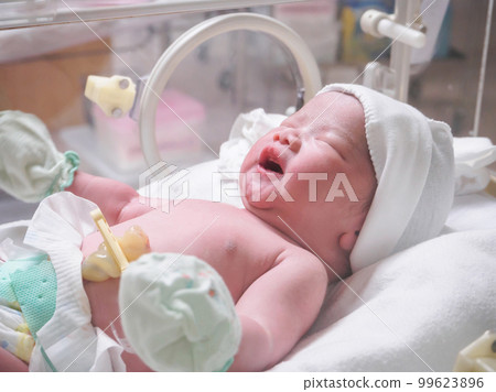 new born baby infant sleep in the incubator at hospital 99623896