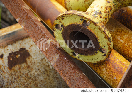 Old rusty metal pipe connection. Scrap metal - predominantly ferrous metals. Waste from industry. 99624203