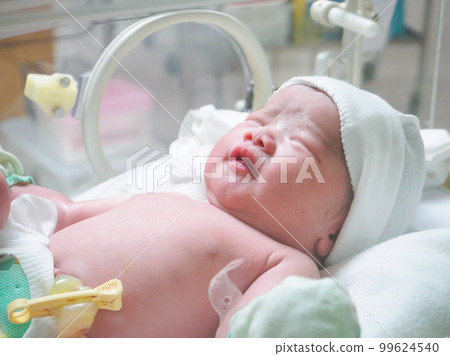 new born baby infant sleep in the incubator at hospital new born baby infant sleep in the incubator at hospital 99624540