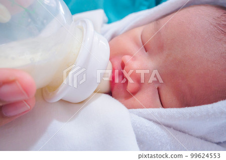 Mother feeding newborn baby from the bottle 99624553