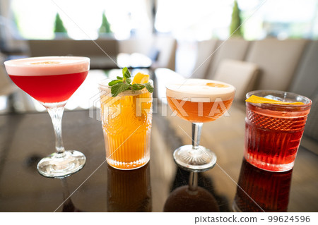 beautiful and delicious alcoholic cocktails prepared at the bar by the bartender. beautiful and delicious alcoholic cocktails prepared at the bar by the bartender. 99624596