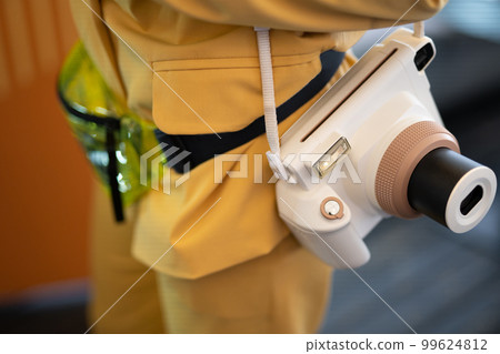 a modern fashionable film camera that takes instant photos. 99624812