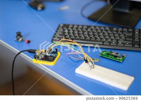 engineers assemble electrical circuits from radio components in a laboratory. 99625369