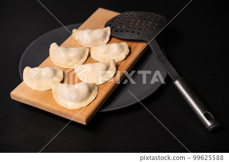 freshly prepared dumplings with kitchen utensils freshly prepared dumplings with kitchen utensils 99625588