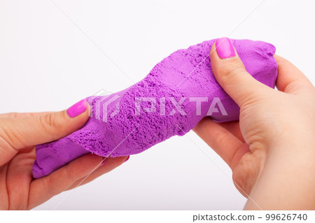 Close-up of a photo in the hands of kinetic sand on a white background Close-up of a photo in the hands of kinetic sand on a white background 99626740
