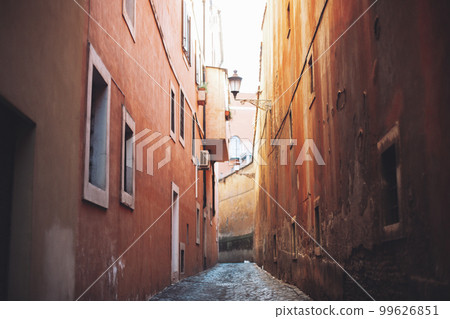 empty narrow city street made of cobblestones between old houses. empty narrow city street made of cobblestones between old houses. 99626851