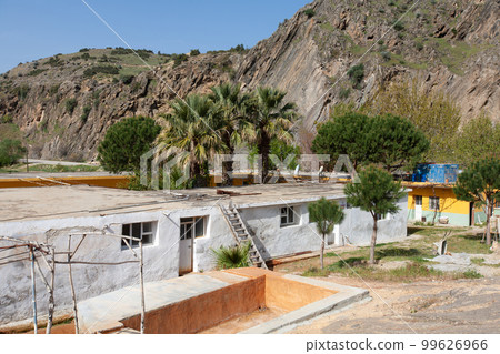 a poor house in a village in the middle of mountains between palm trees in Turkey. 99626966