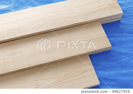 Cedar plank wood on blue sheet 99627958