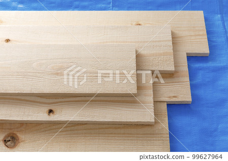 Cedar plank wood on blue sheet Cedar plank wood on blue sheet 99627964