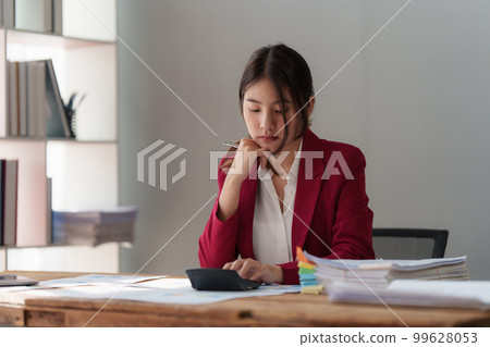 Tired business woman in stress works with many paperwork document. migraine attack. Freelance, work from home Tired business woman in stress works with many paperwork document. migraine attack. Freelance, work from home 99628053