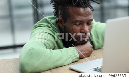 businessman working on his laptop during a late night shift at work. 99628285