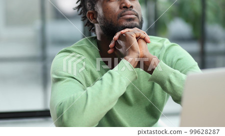 Business man in casual clothes thinking behind a laptop 99628287