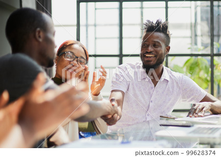 african business people handshake at modern office 99628374