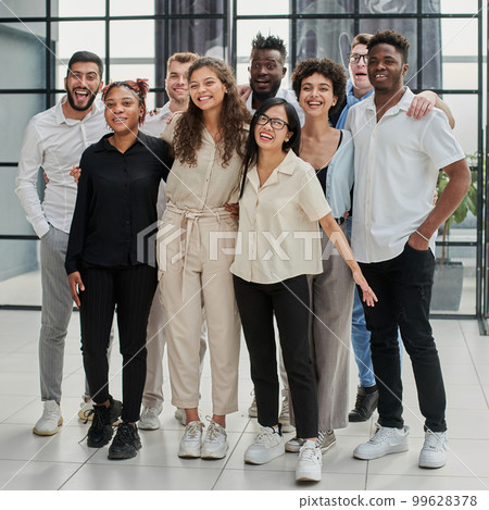 Team at work. Group of young business people in smart casual wear working together in creative office Team at work. Group of young business people in smart casual wear working together in creative office 99628378