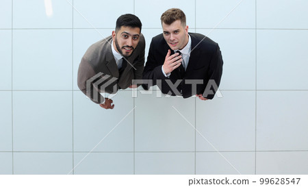 Portrait of two concentrated businessmen partners dressed in formal suit Portrait of two concentrated businessmen partners dressed in formal suit 99628547