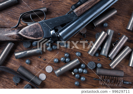 Antique 16-gauge break-action smooth-bored shotgun with brass cases and accessories for cartridge reloading. 99629711