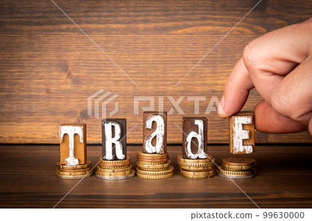 TRADE. Concept of finance and economics. Text and money on a wooden background 99630000