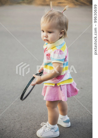 charming little tennis player with a racket  99630699