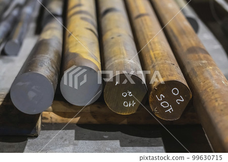 Round long metal billets at a steel mill Round long metal billets at a steel mill 99630715