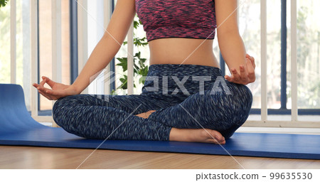 Yoga fitness lifestyle healthy woman relaxation doing a meditation. Yoga meditate outdoor with zen on sitting position. Yoga woman workout in sportswear sit on yoga mat home fitness workout exercise Yoga fitness lifestyle healthy woman relaxation doing a meditation. Yoga meditate outdoor with zen on sitting position. Yoga woman workout in sportswear sit on yoga mat home fitness workout exercise 99635530