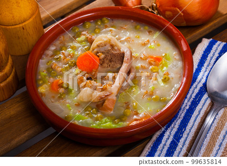 Lamb's soup cooked with pearl barley, green peas and cabbage 99635814