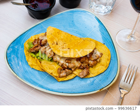 Mexican tacos with fried chicken, guacamole and salsa Mexican tacos with fried chicken, guacamole and salsa 99636617