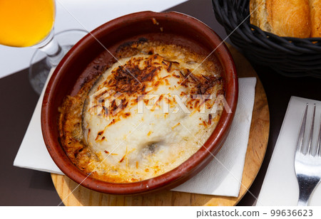 Traditional Balkan Moussaka dish served with fresh bread in pottery. 99636623