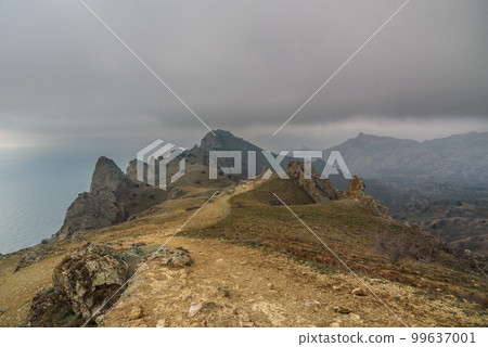 Landscape of Karadag Reserve in spring. View of rocks of ridge Karagach. Crimea 99637001