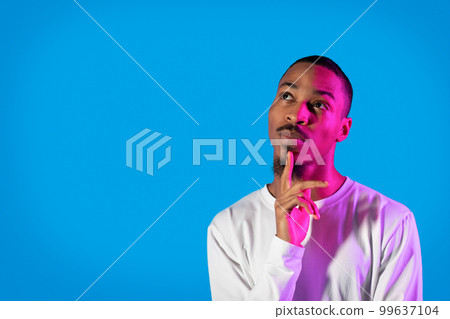 Pensive black guy thinking about something, looking at copy space Pensive black guy thinking about something, looking at copy space 99637104