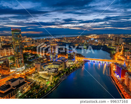 Yekaterinburg city and pond aerial panoramic view at summer or early autumn night. Night city in the early autumn or summer. Yekaterinburg city and pond aerial panoramic view at summer or early autumn night. Night city in the early autumn or summer. 99637168
