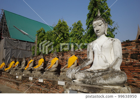 Row of Buddha statues at Wat Yai Chaimongkhon in Ayutthaya, Thailand 99638950