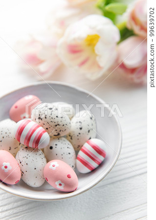 Easter eggs painted pastel colors on a white wooden background. Easter eggs painted pastel colors on a white wooden background. 99639702