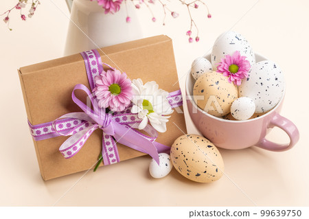 Gift box, Easter eggs and flowers Gift box, Easter eggs and flowers 99639750