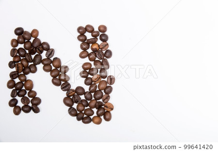 N is a capital letter of the English alphabet made up of natural roasted coffee beans that lie on a white background. N is a capital letter of the English alphabet made up of natural roasted coffee beans that lie on a white background. 99641420