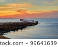 Old abandoned damaged fishing boat laying on the stone pier 99641639