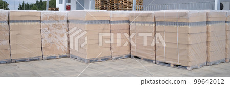 Rows of boxes and pallets in warehouse and production warehouse 99642012