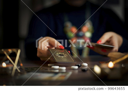 Blurred tarot cards on the table, esoteric concept, fortune telling predictions Blurred tarot cards on the table, esoteric concept, fortune telling predictions 99643655