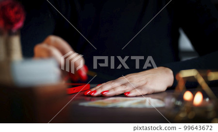 Blurred tarot cards on the table, esoteric concept, fortune telling predictions Blurred tarot cards on the table, esoteric concept, fortune telling predictions 99643672