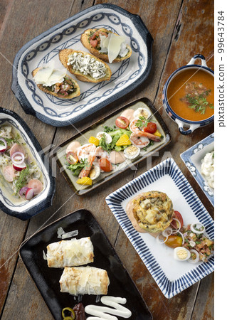 selection of many different tapas on rustic wood table 99643784