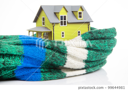 house model is insulated with a knitted scarf on a white background. house model is insulated with a knitted scarf on a white background. 99644981