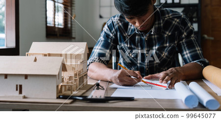 Concept architects, engineer or architect holding pen drawing on blueprint architectural. equipment architects On the desk with a blueprint in the office 99645077