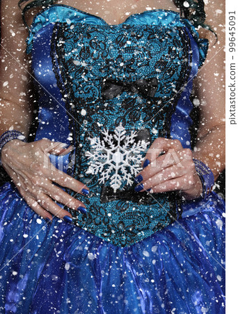 Woman wearing Blue Corset with snowflake ornament and snow storm 99645091