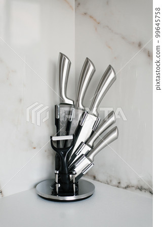 A set of kitchen knives on a stand in the kitchen A set of kitchen knives on a stand in the kitchen 99645758
