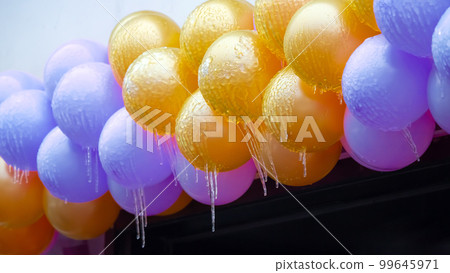 icicles on frozen colored inflatable holiday balls. winter weather season. street interior details icicles on frozen colored inflatable holiday balls. winter weather season. street interior details 99645971
