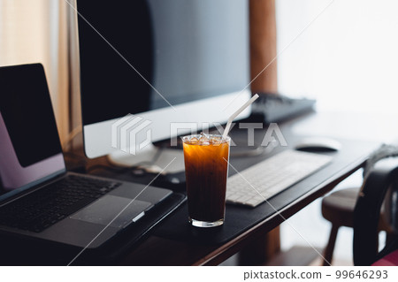 iced coffee on desk at home 99646293