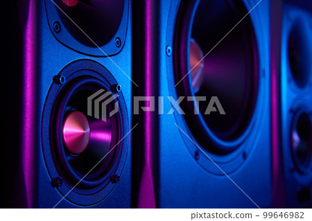 Two sound speakers and subwoofer on dark background with neon lights. Set for listening music. Audio equipment Two sound speakers and subwoofer on dark background with neon lights. Set for listening music. Audio equipment 99646982