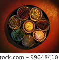 a round box of chocolates in which some of the sweets were replaced with Christmas decorations 99648410