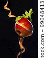 apple and celery leaf wrapped with tailor's ribbon on a fork 99648413